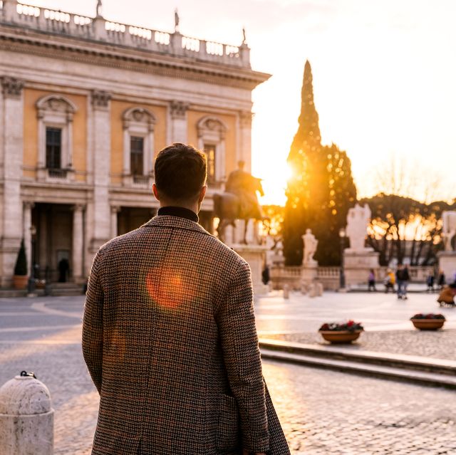 rear view of a man on capitoline hill at sunset, rome, italy