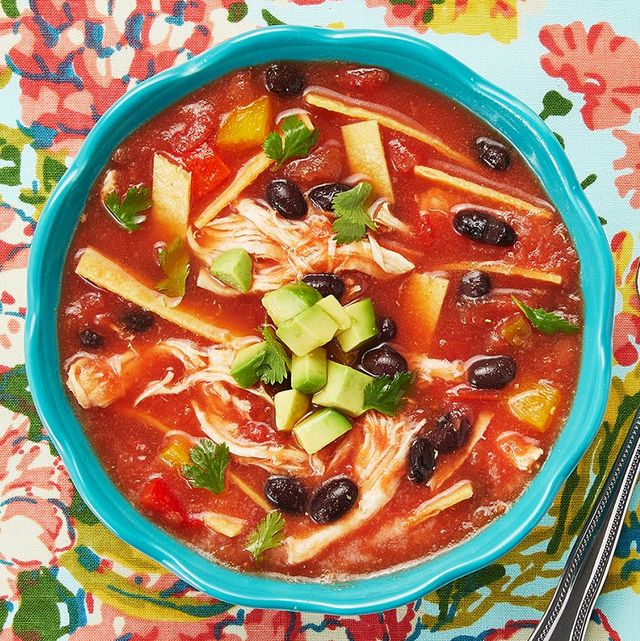 chicken tortilla soup overhead in blue bowl floral background