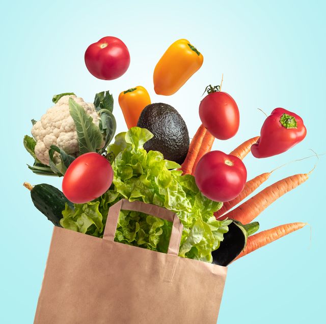 recyclable bag of fresh vegetables on blue summer sky background