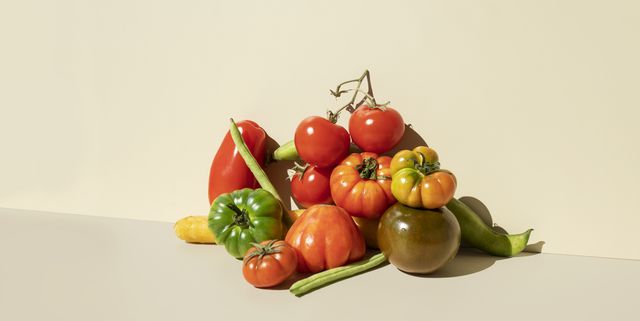 red,green tomatoes, carrots and green beans on the beige background