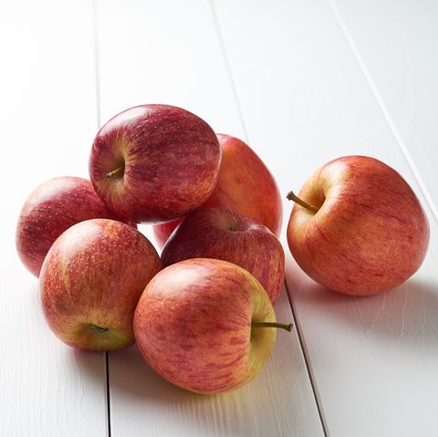 red ripe apples on a white wooden background
 vegetarian, vegan, raw food