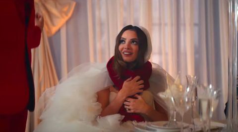 a bride wearing a red scarf in the i bet you think about me music video
