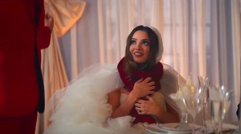 a bride wearing a red scarf in the i bet you think about me music video