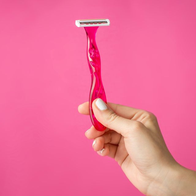 red shaver in woman hands
