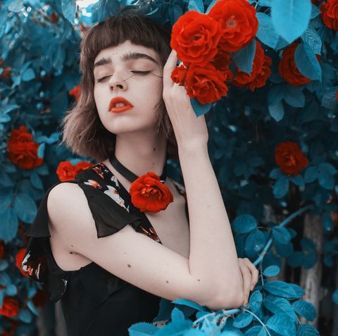 redhead model on background of roses bush fabulous