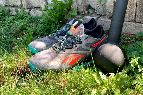 reebok nano x2 adventure shoes in the grass next to a weight