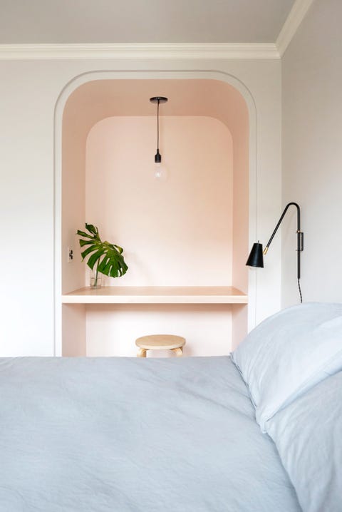 bedroom with small pink workspace