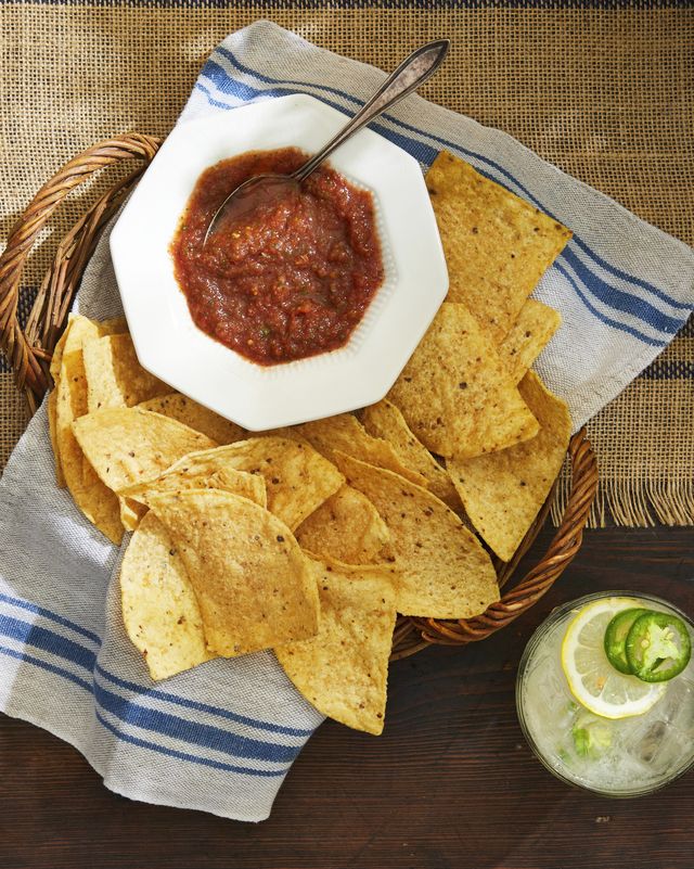 restaurant style salsa with a basket of chips