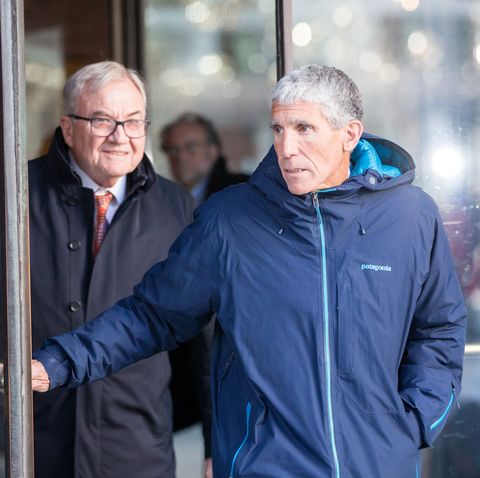 rick singer exiting a courthouse wearing a blue patagonia jacket