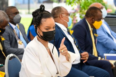 rihanna in a white dress and blazer during barbados' national honors ceremony