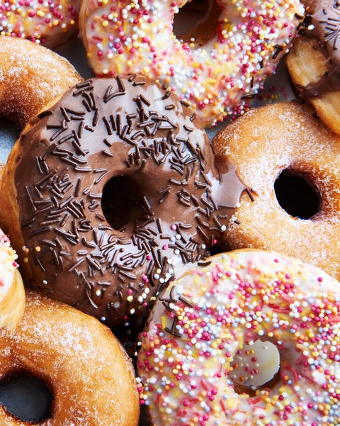 Ring doughnuts covered in icing and sprinkes Ring doughnuts covered in icing and sprinkes
