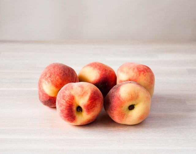 ripe fresh peach fruits whole on white