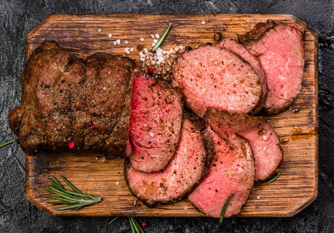 Roast Beef On Cutting Board With Salt And Pepper. Top View. Roast Beef On Cutting Board With Salt And Pepper. Top View.
