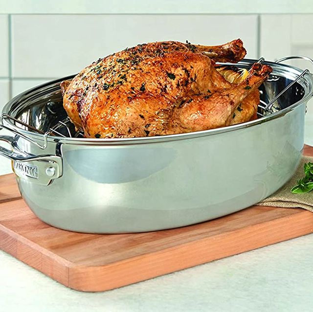 a roasted turkey sitting in a pan on a counter