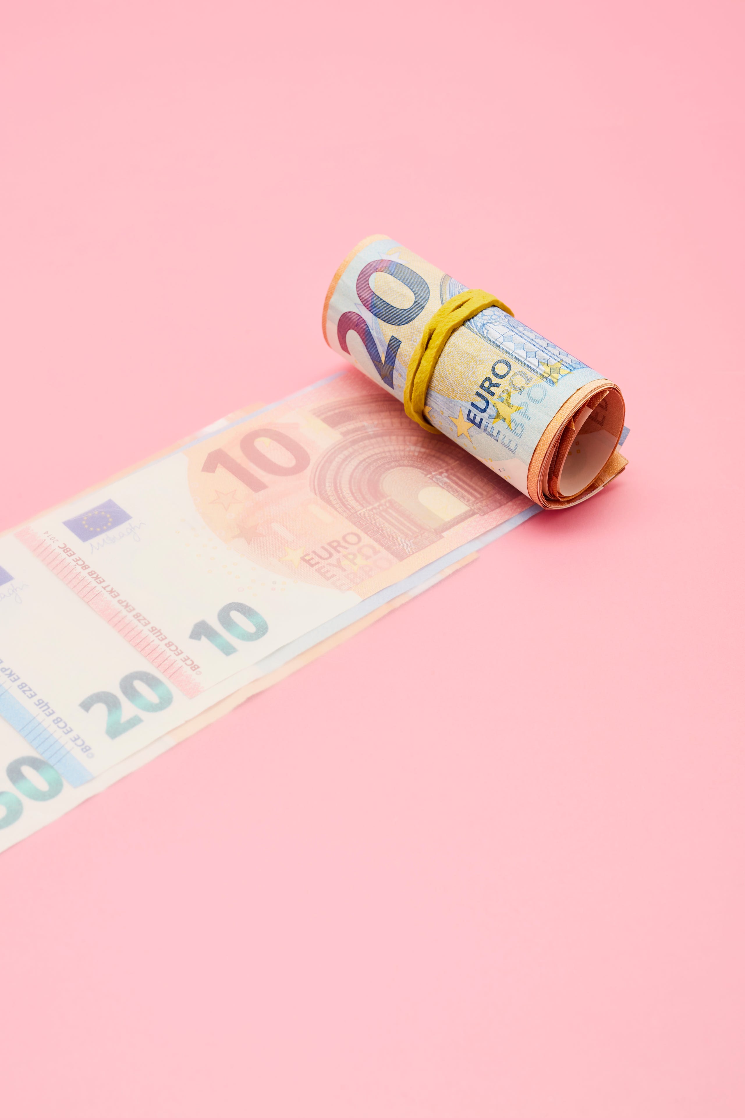 https://hips.hearstapps.com/hmg-prod.s3.amazonaws.com/images/roll-of-euro-banknotes-on-pink-background-royalty-free-image-1575031957.jpg?resize=2560:*