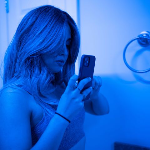 roo powell taking a selfie in blue light