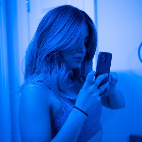 roo powell taking a selfie in blue light