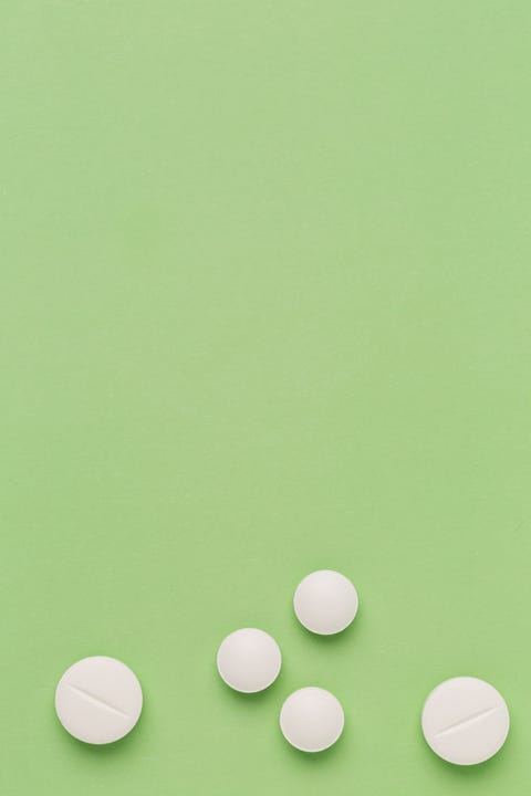 Round white pills on colorful background