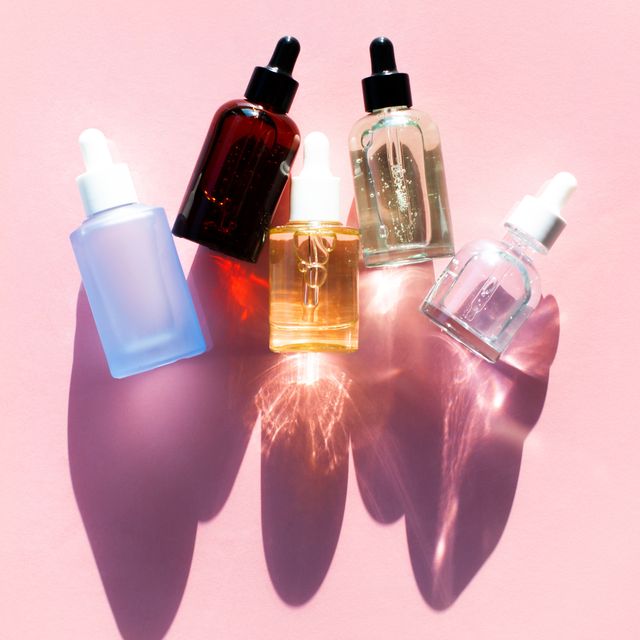 row of serums on pink background