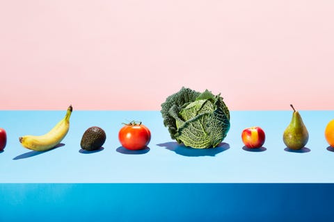 A row of different fruits and vegetables on a table top