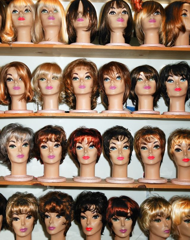rows of female mannequin heads on shelves