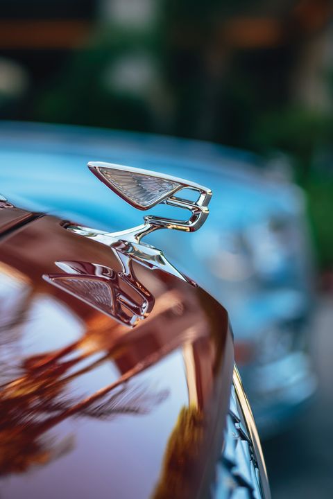 front hood of a bentley showing the emblem