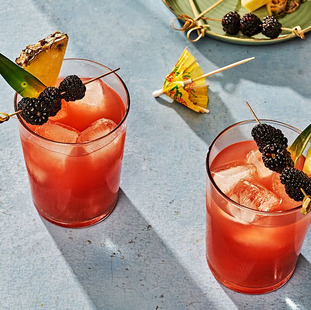 rum runner cocktail garnished with pineapple and blackberries