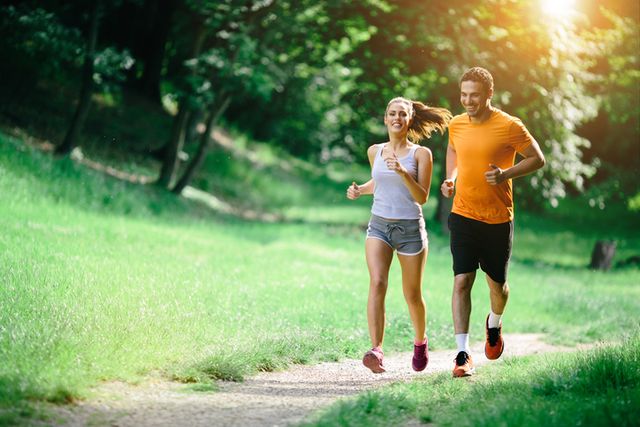healthy couple jogging in nature in good spirit