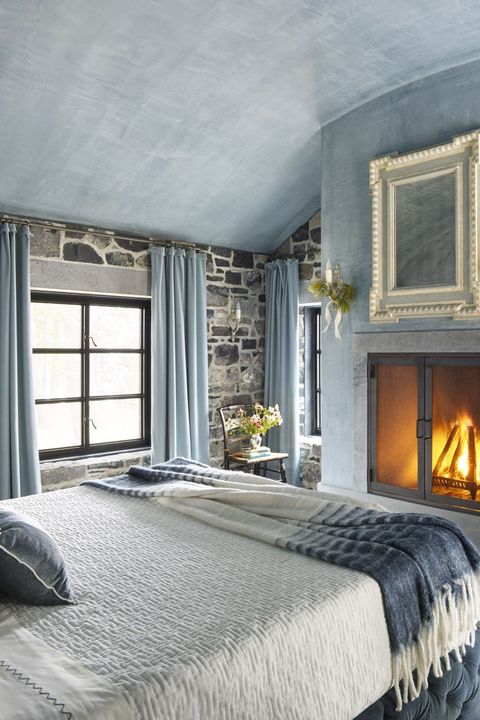 blue rustic bedroom with fireplace