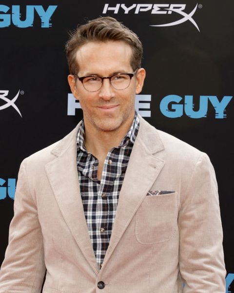ryan reynolds wears a tan suit and plaid shirt on the red carpet