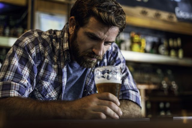 sad man sitting in beer bar
