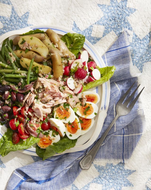 salade niçoise on a plate on a picnic blanket