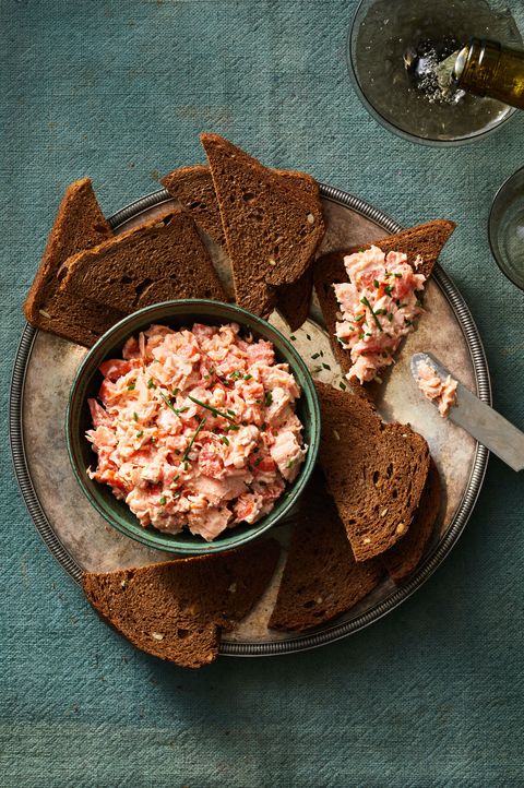 salmon rillette with slices of pumpernickel bread on the side