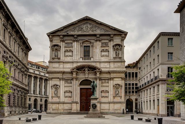 san fedele square in the morning, with the statue of alessandro manzoni and the facade of san fedele church