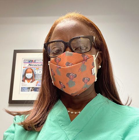 sandra lindsay in light green scrubs and an orange face mask at work at the hospital