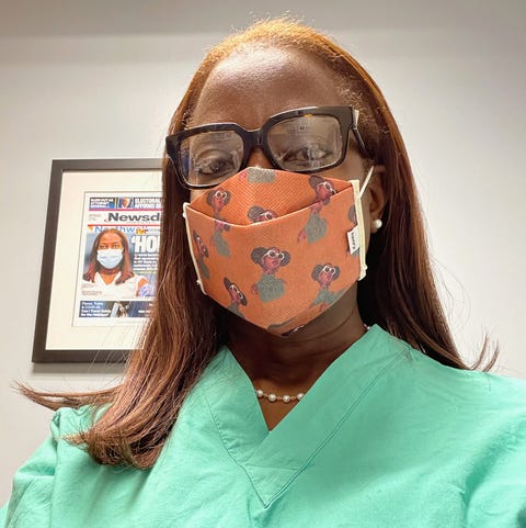 sandra lindsay in light green scrubs and an orange face mask at work at the hospital