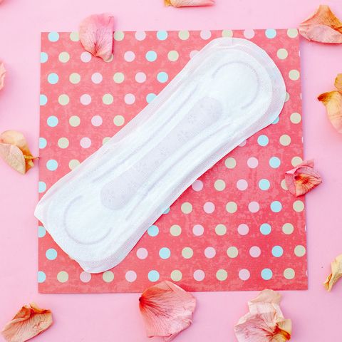 sanitary pad with rose petalspink background