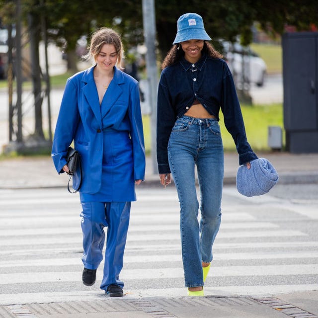 a woman walks at copenhagen fashion week wearing jeans