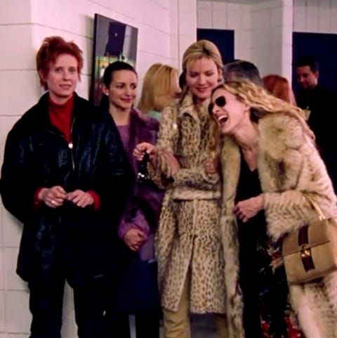 carrie wearing a floral dress, a fur jacket, and a gucci purse at a baseball game