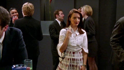 charlotte in a white button down shirt and lipstick printed skirt