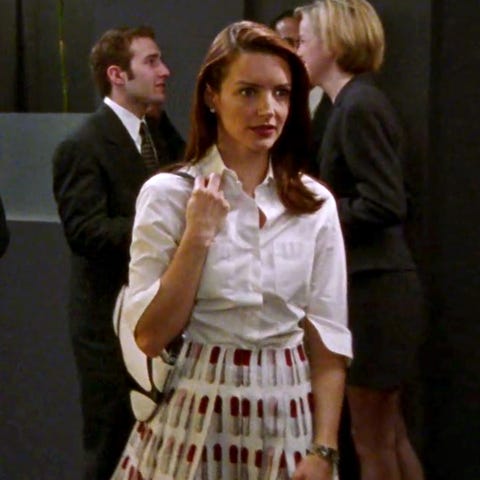 charlotte in a white button down shirt and lipstick printed skirt
