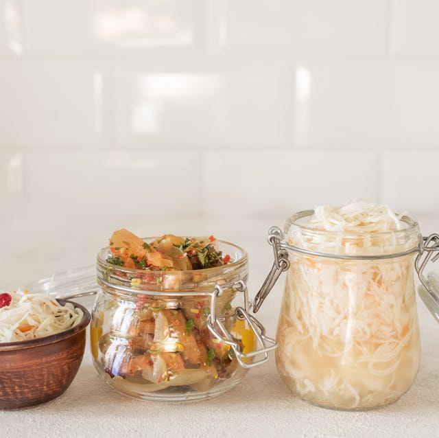 Sauerkrau, marinated pickles variety preserving jars. Homemade red cabbage beetroot , turmeric yellow kraut, cauliflower, radish, carrots, chili peppers, squash, green beans pickles. Fermented food. fermented foods
