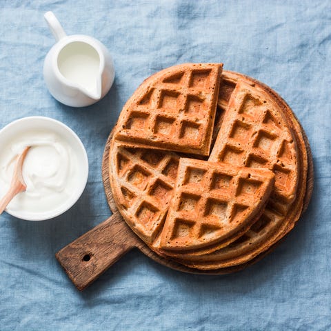 Savory gluten free breakfast waffles on a blue background, top view. Vegetarian food concept