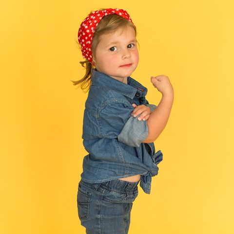 little girl dressed in denim shirt and pants as rosie the riverter