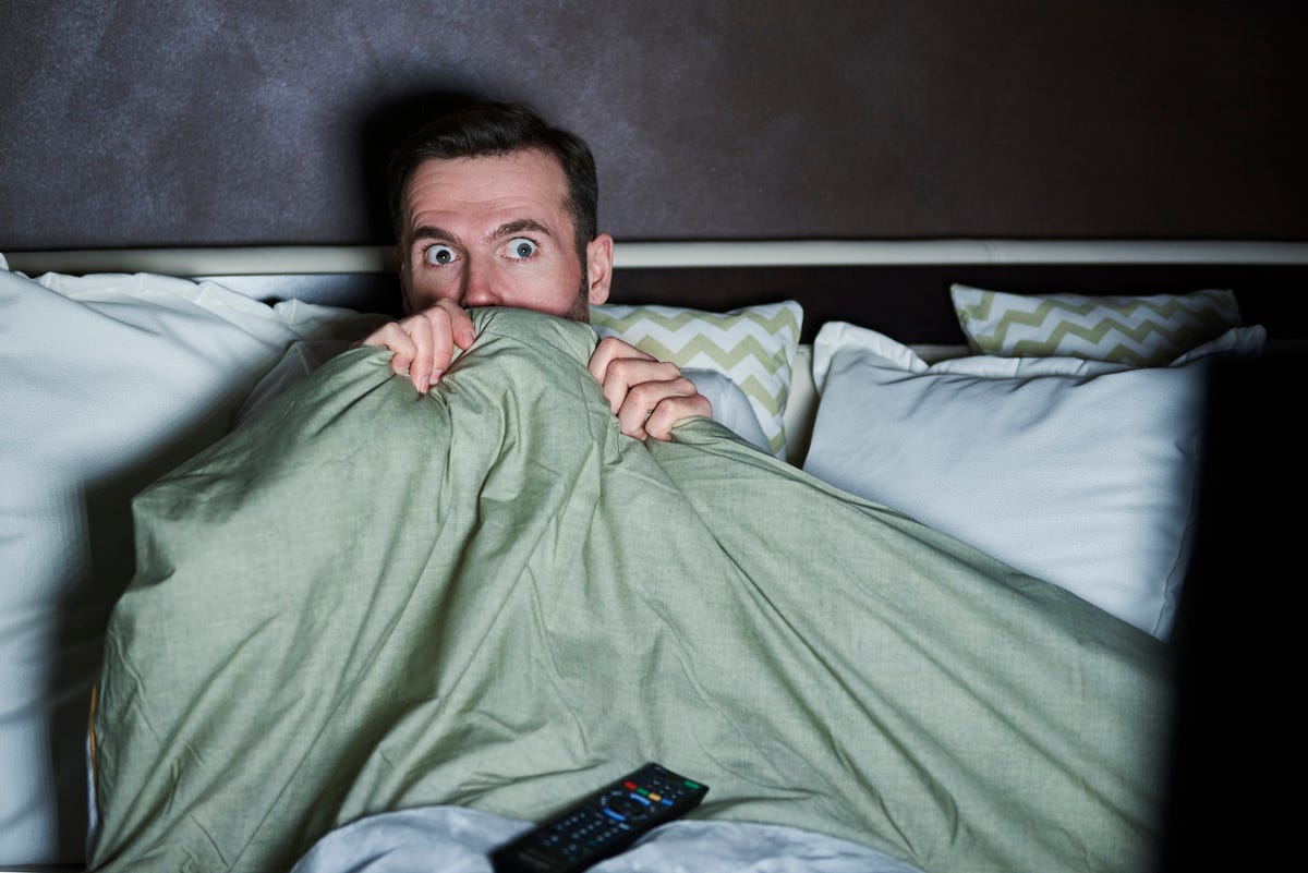 scared-man-watching-horror-movies-at-night-royalty-free-image-1605005383.?crop=1.00xw:0.751xh;0,0.0983xh&resize=1200:*