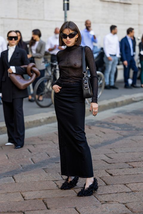 milan, italy september 22 a guest wears see trough black shirt, high waisted pants, heels, bag outside max mara during the milan fashion week womenswear springsummer 2023 on september 22, 2022 in milan, italy photo by christian vieriggetty images