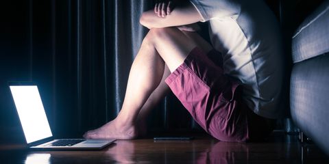 Scene of man use laptop alone in dark room conceptual of depression disorder, mental health issue with social media effect, wide dimension for banner
