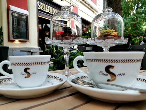 white coffee cups and berry tarts