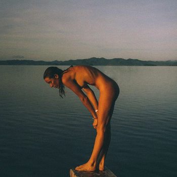 Nuria Val naked at a lake.