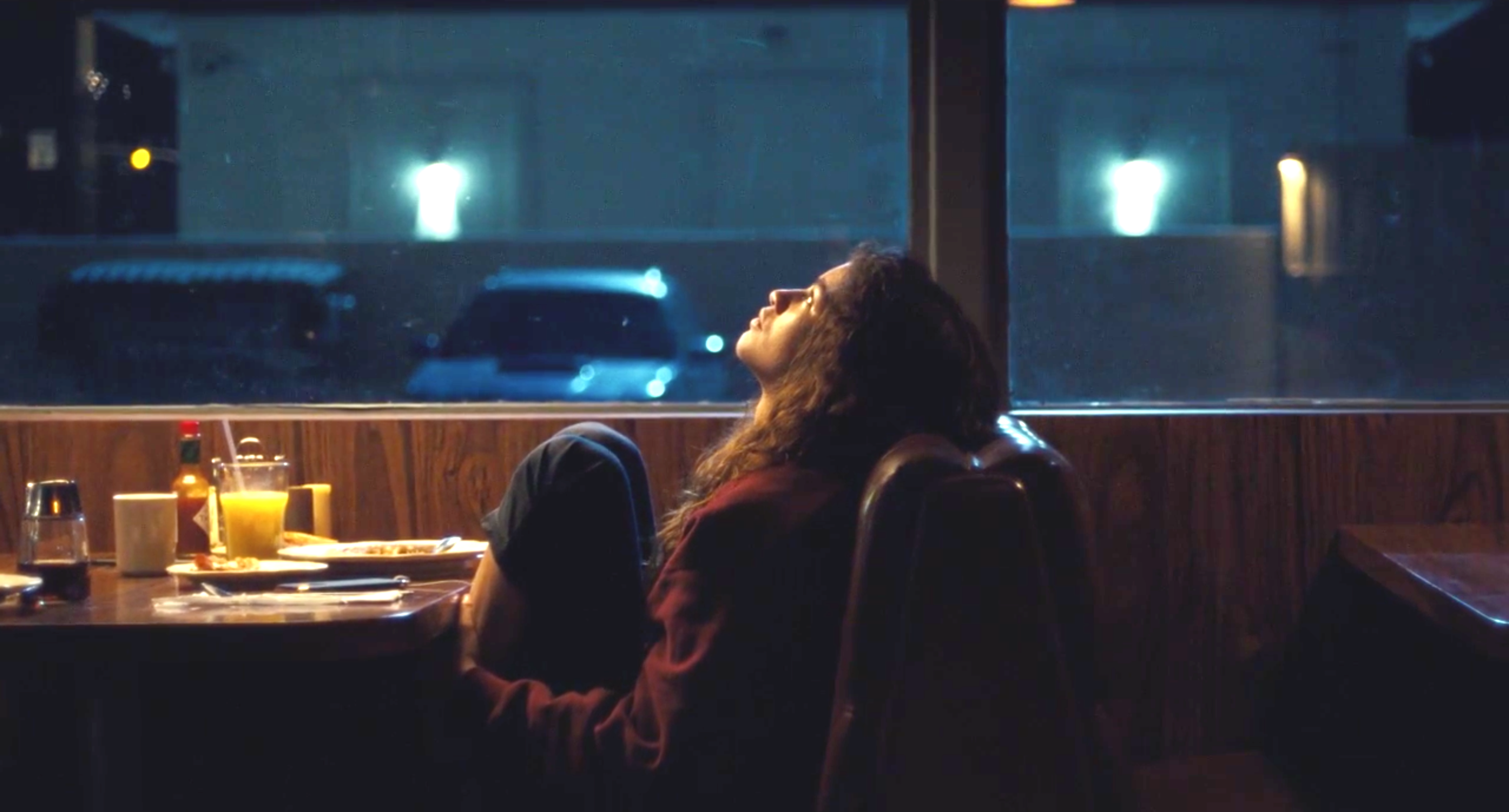 Rue stares up in a diner booth in Euphoria
